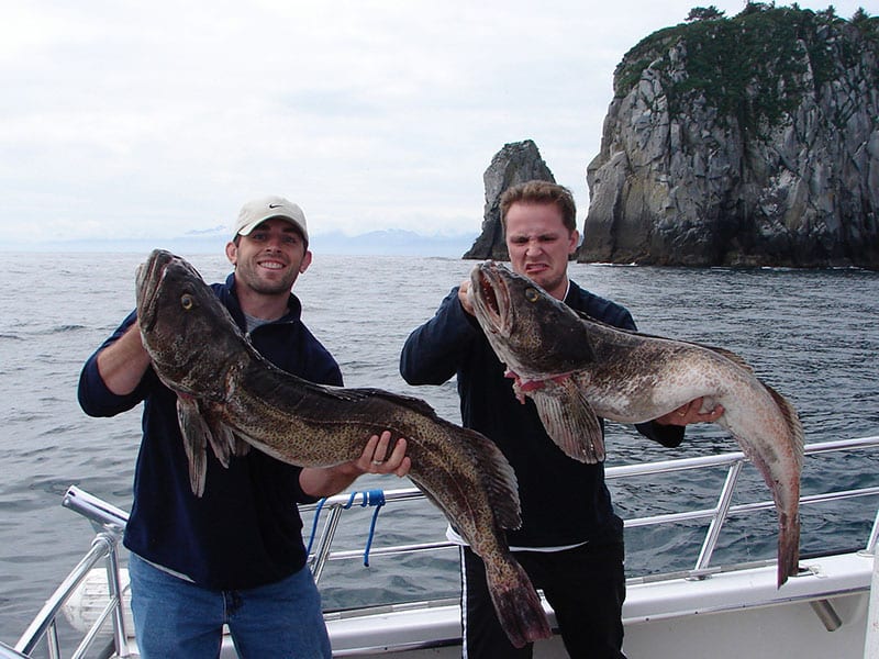 Two anglers pose with their fish.