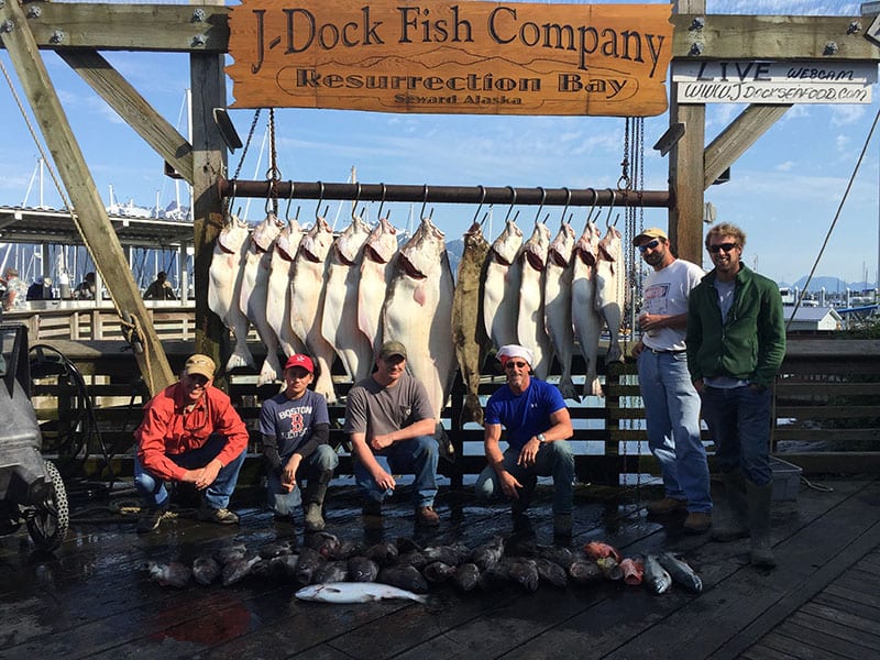 6 anglers poses with their halibut catch