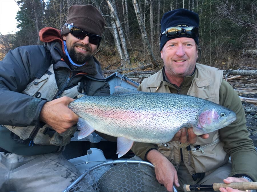 An angler poses with his large rainbow trout.